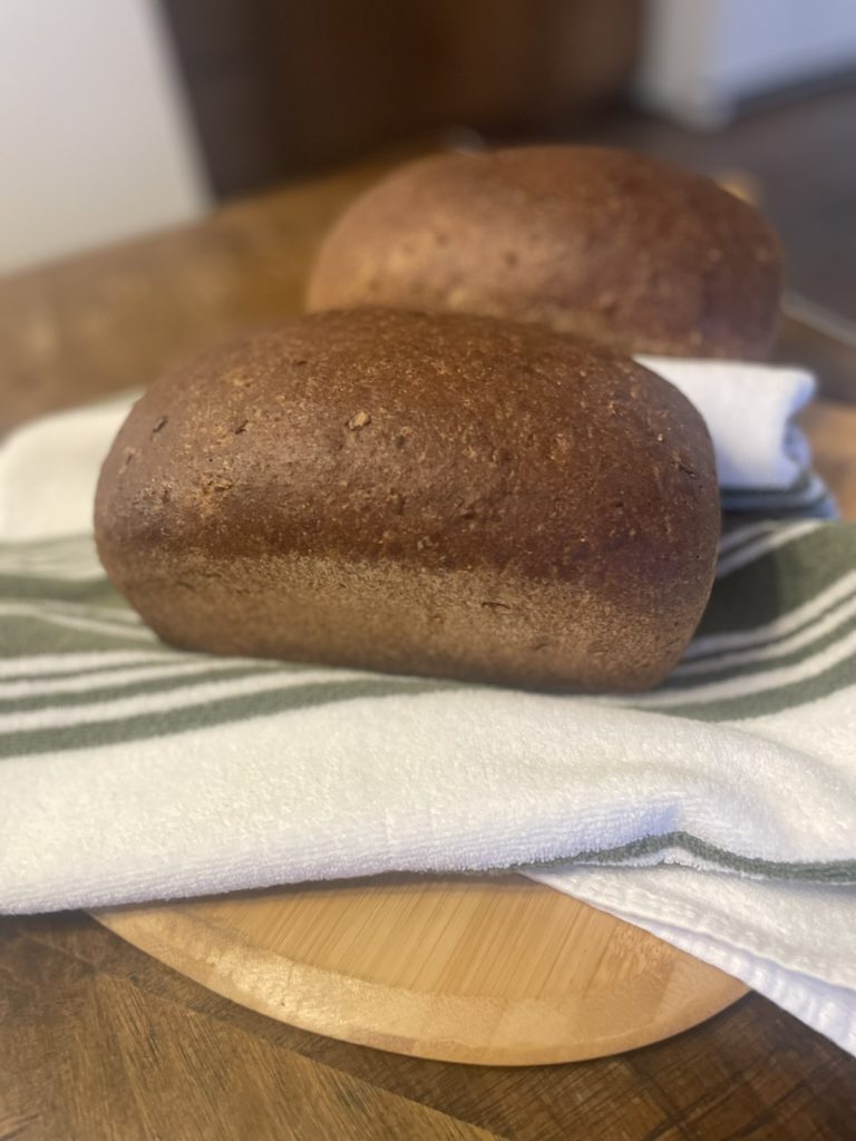 wheat bread on towel on a cutting board